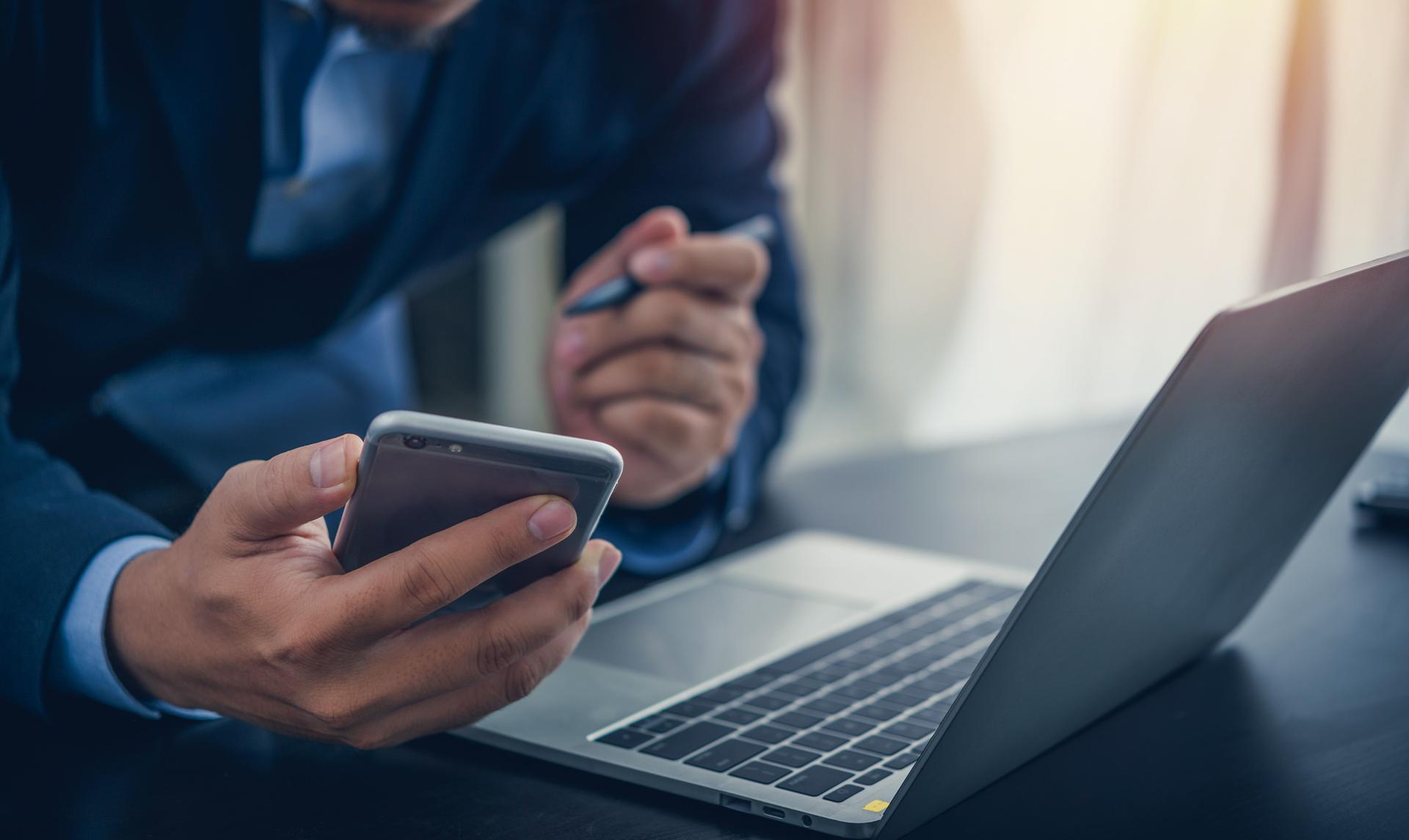 Business man use smartphone with laptop computer at office artificial intelligence technology global iot providing virtual, customer support and information.